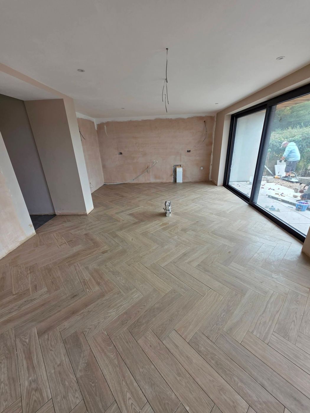 Finished herringbone floor across a new-build living space in the Vale of Glamorgan