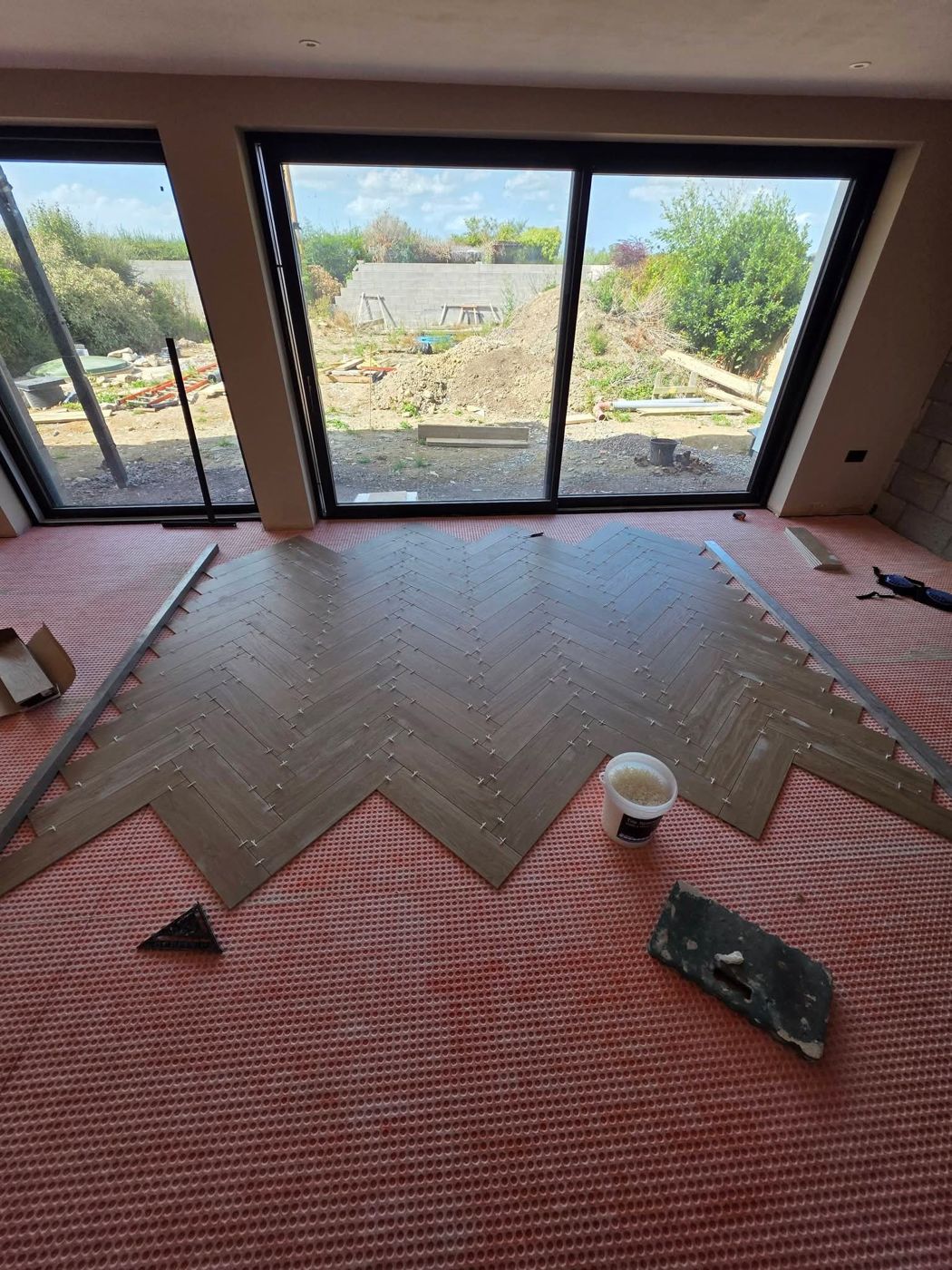 Herringbone being set out across the matted floor