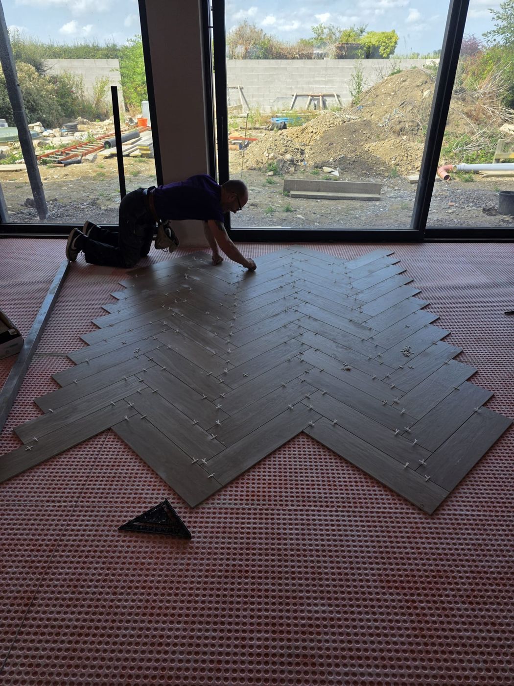 Kenny laying a herringbone floor in a new-build house in the Vale of Glamorgan